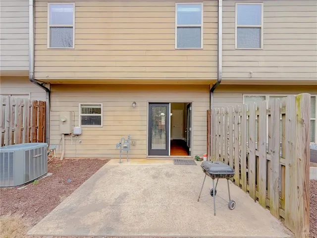 a backyard of a house with table and chairs