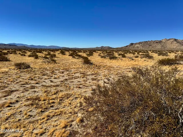 a view of mountain with an ocean