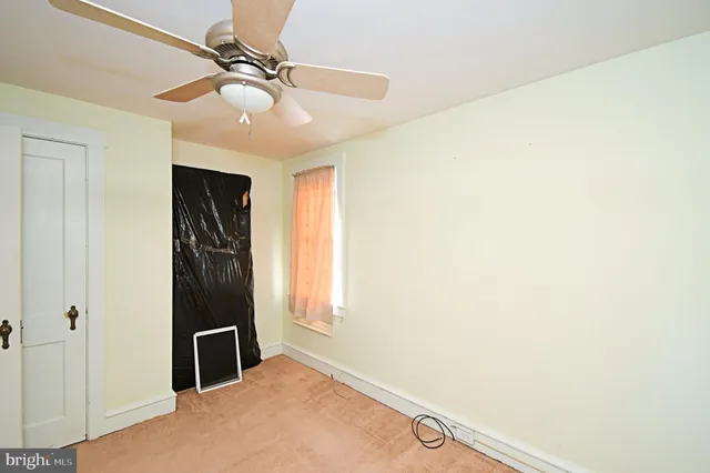 a view of a hallway with a ceiling fan