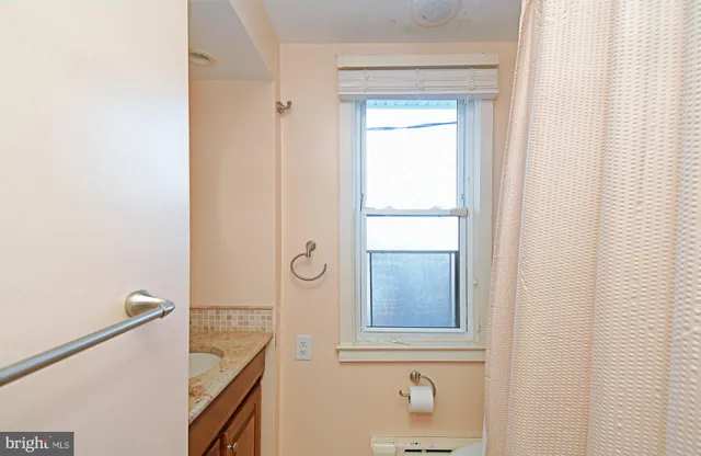 a bathroom with a shower and a sink