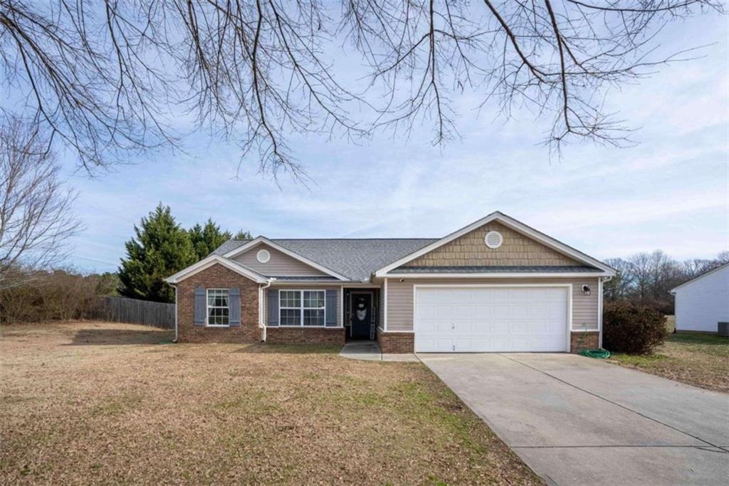 302 Simeon Road Statham, GA 30666 - Photo 1 of 1 a front view of a house with a yard and garage