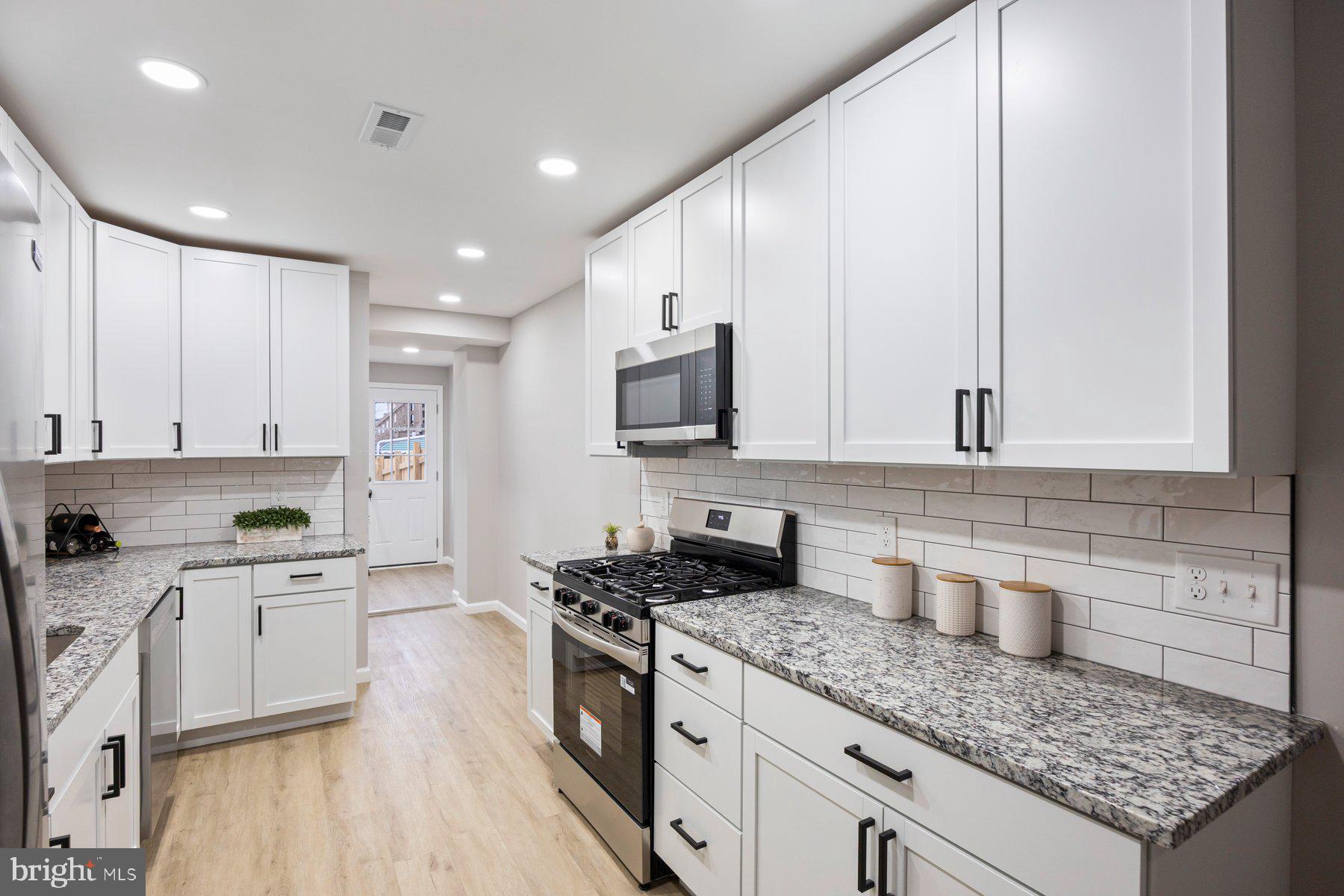 3611 Chestnut Avenue Baltimore, MD 21211 - Photo 14 of 38 a kitchen with granite countertop a sink stainless steel appliances and cabinets