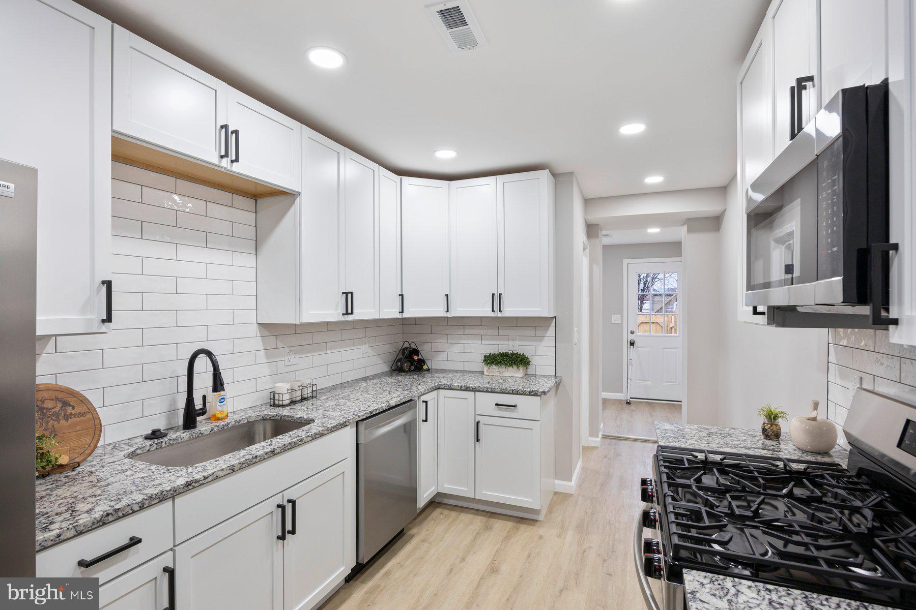 3611 Chestnut Avenue Baltimore, MD 21211 - Photo 15 of 38 a kitchen with a sink stove and cabinets