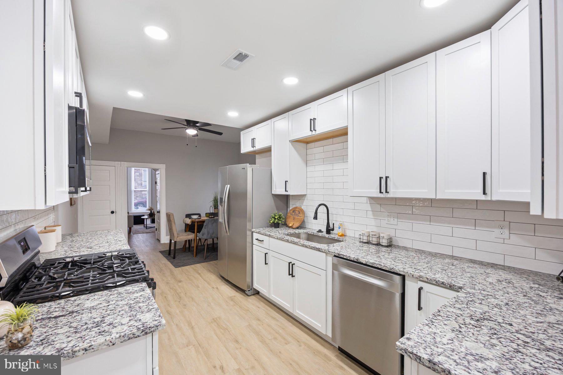 3611 Chestnut Avenue Baltimore, MD 21211 - Photo 16 of 38 a kitchen with a sink stove and cabinets