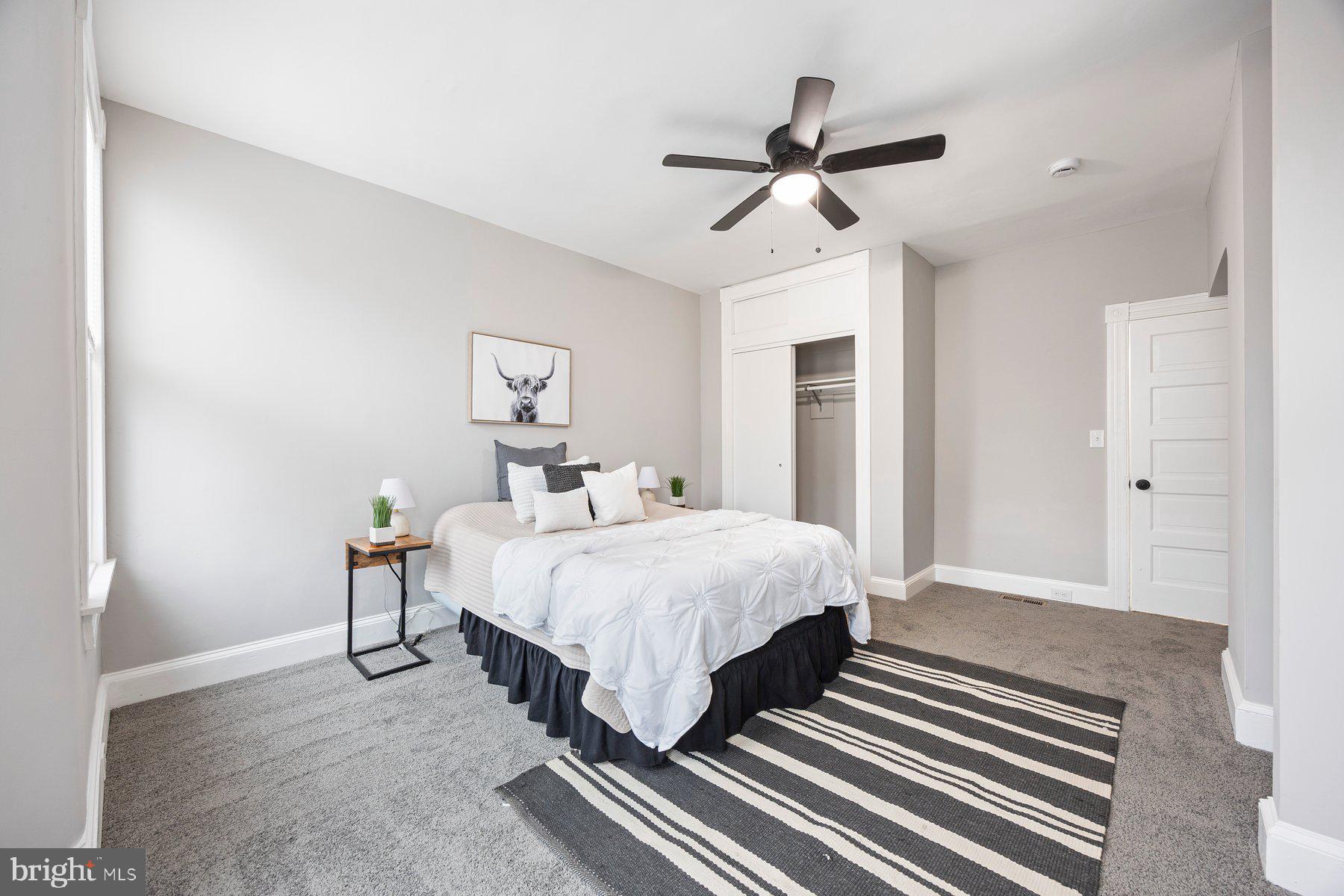 3611 Chestnut Avenue Baltimore, MD 21211 - Photo 23 of 38 a spacious bedroom with a bed and a chandelier