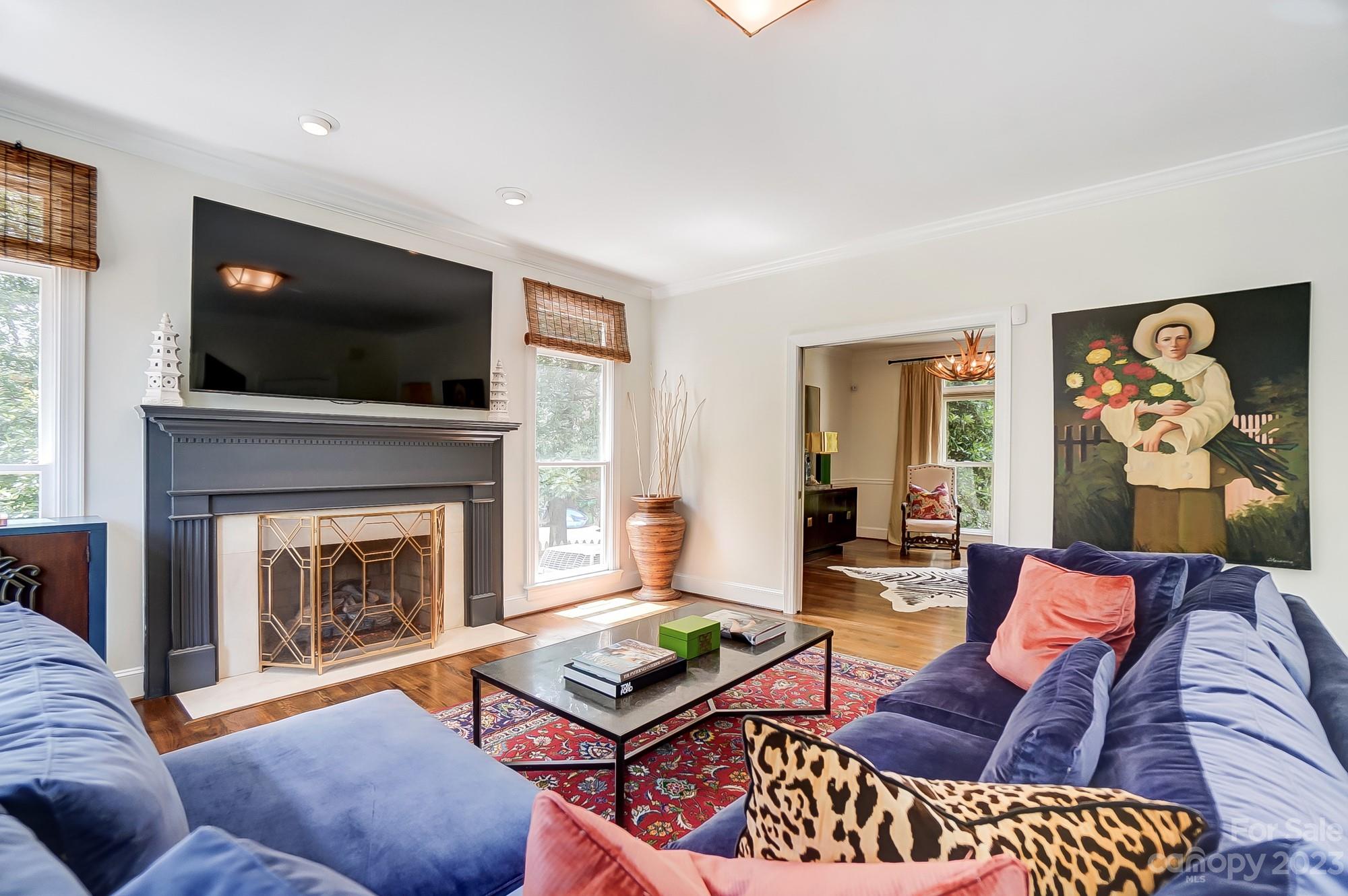 2407 Queensland Drive Charlotte, NC 28270 - Photo 12 of 42 a living room with furniture a flat screen tv and a fireplace
