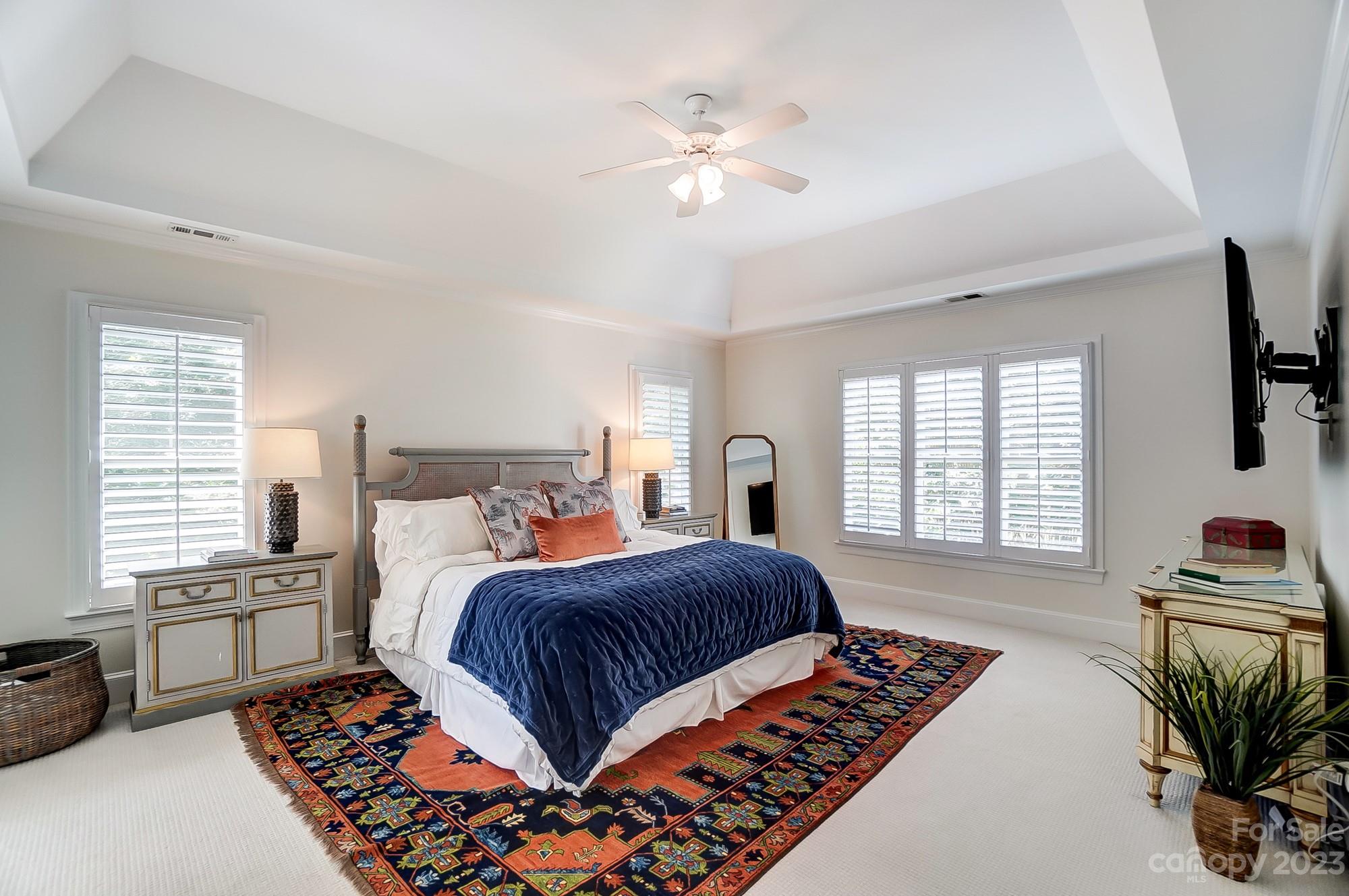 2407 Queensland Drive Charlotte, NC 28270 - Photo 16 of 42 a bedroom with a large bed a fireplace and windows