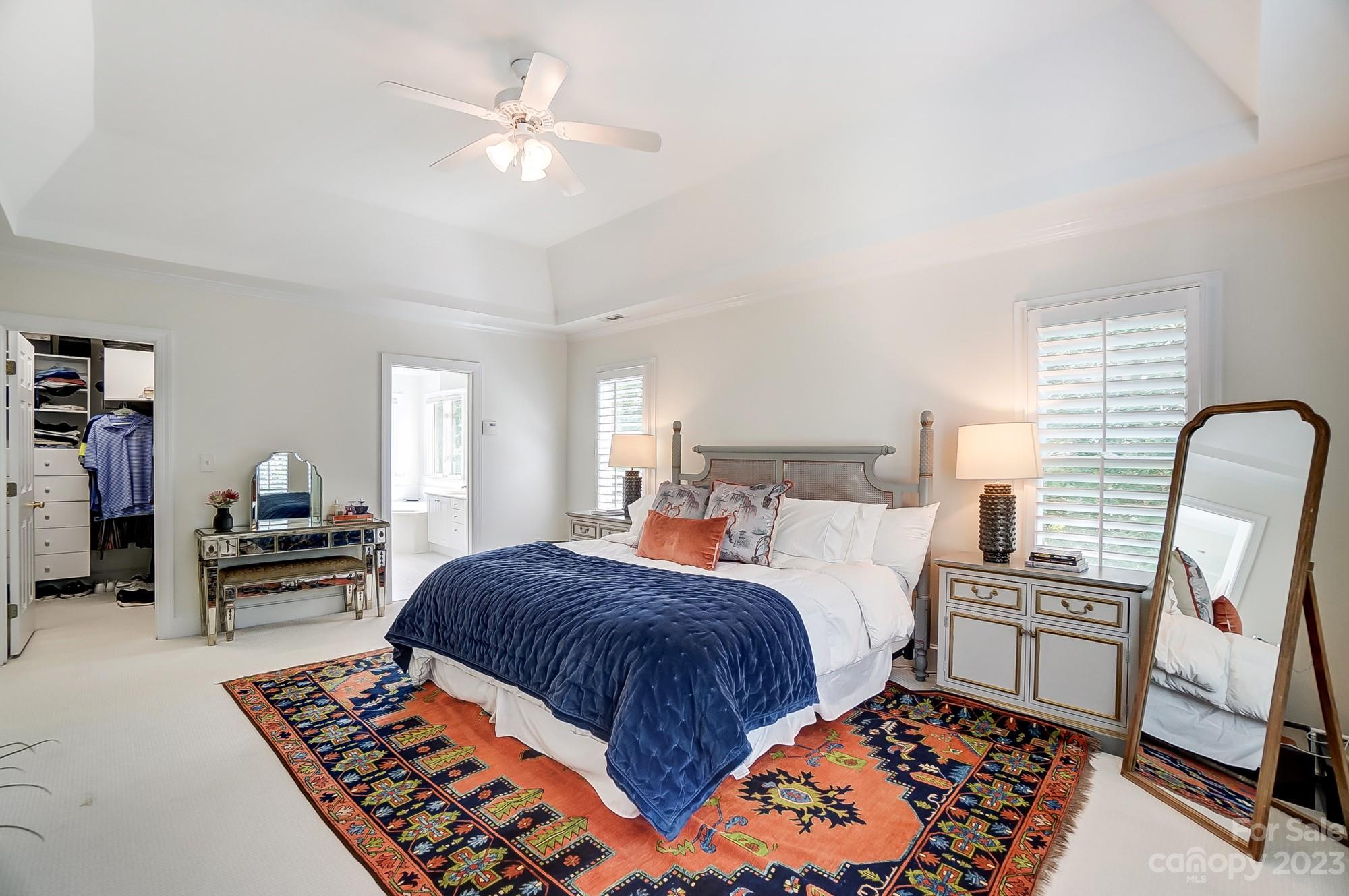 2407 Queensland Drive Charlotte, NC 28270 - Photo 17 of 42 a bedroom with a bed and a chandelier