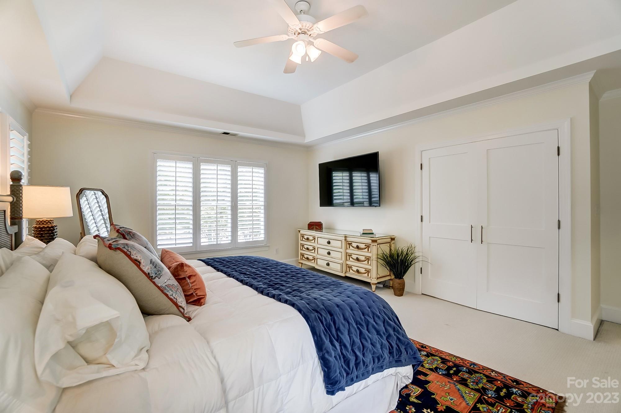 2407 Queensland Drive Charlotte, NC 28270 - Photo 19 of 42 a bedroom with a bed and a chandelier