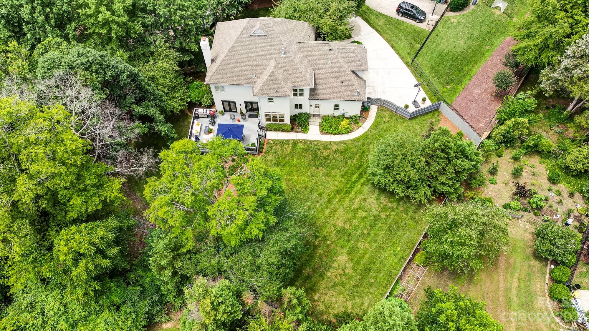 2407 Queensland Drive Charlotte, NC 28270 - Photo 2 of 42 an aerial view of a house with a garden and trees