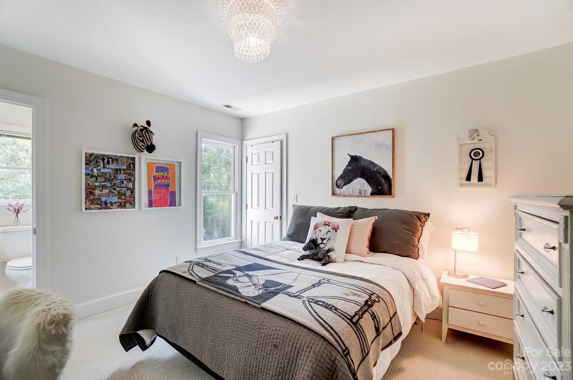 2407 Queensland Drive Charlotte, NC 28270 - Photo 23 of 42 a bedroom with a bed and a painting on the wall