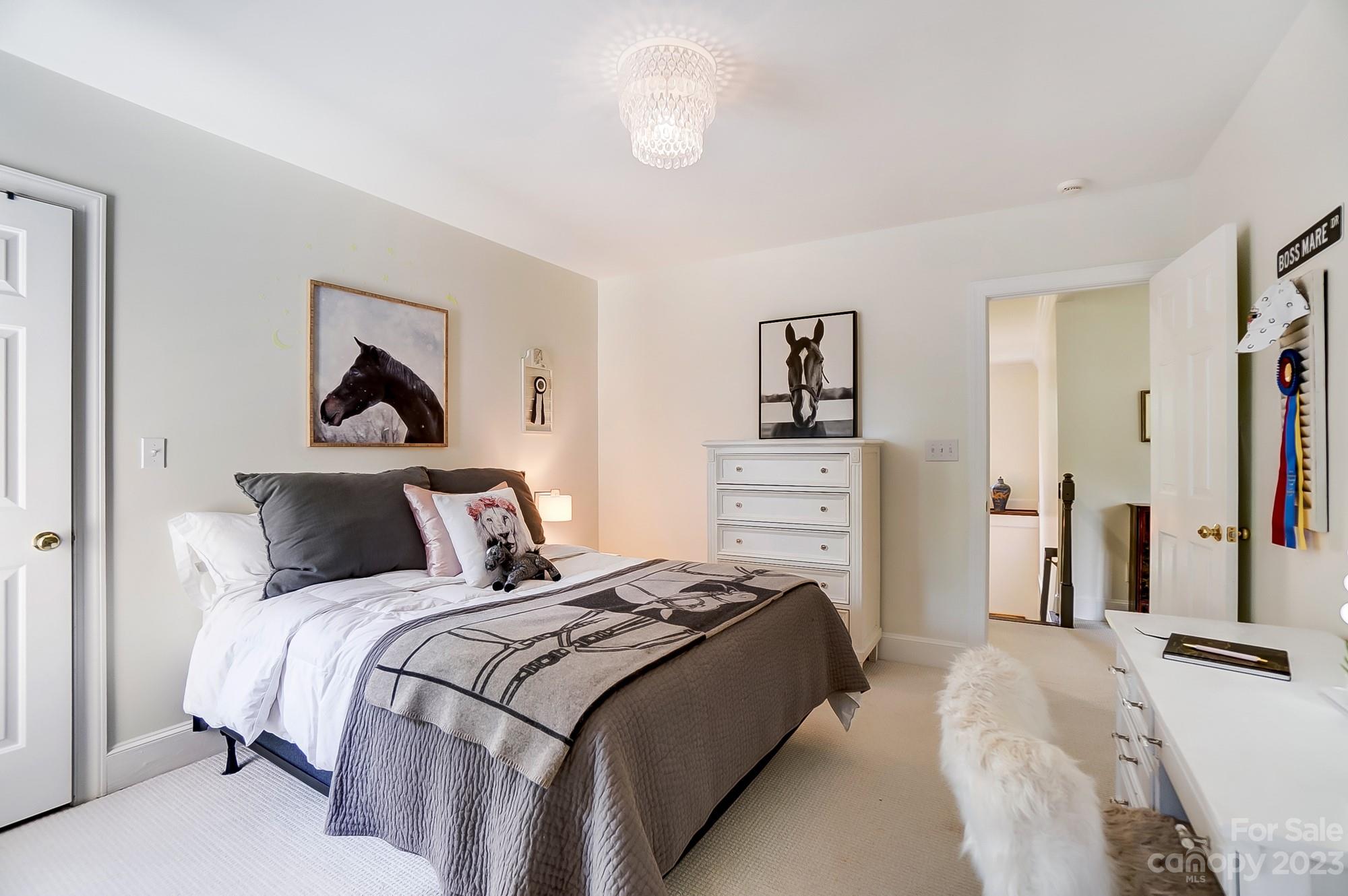 2407 Queensland Drive Charlotte, NC 28270 - Photo 25 of 42 a bedroom with a bed and a chandelier