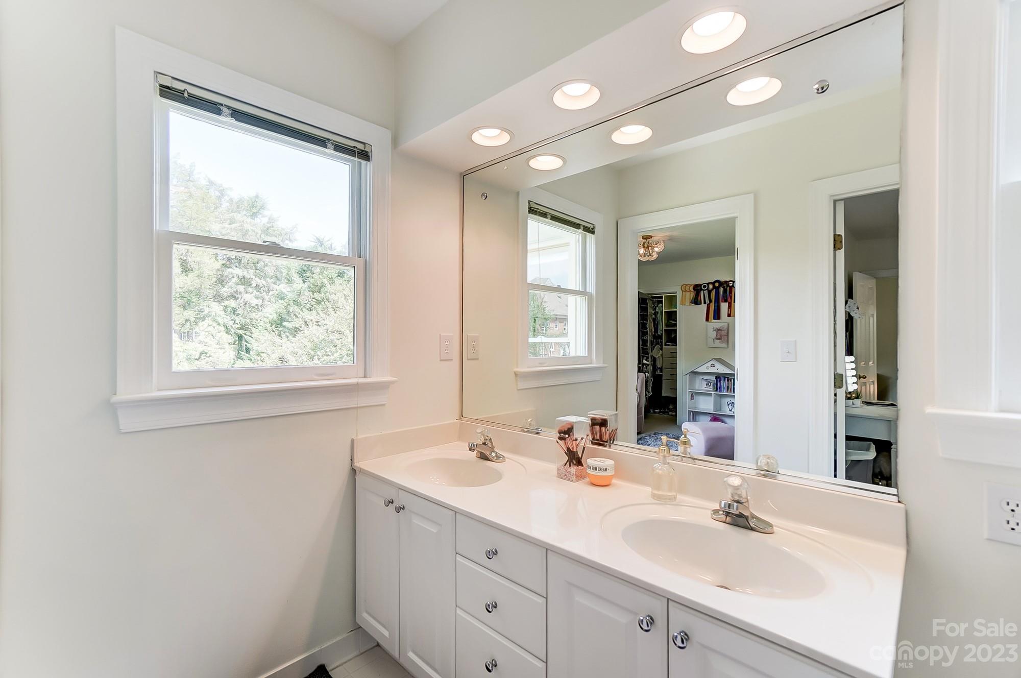 2407 Queensland Drive Charlotte, NC 28270 - Photo 26 of 42 a bathroom with a double vanity sink window and a mirror