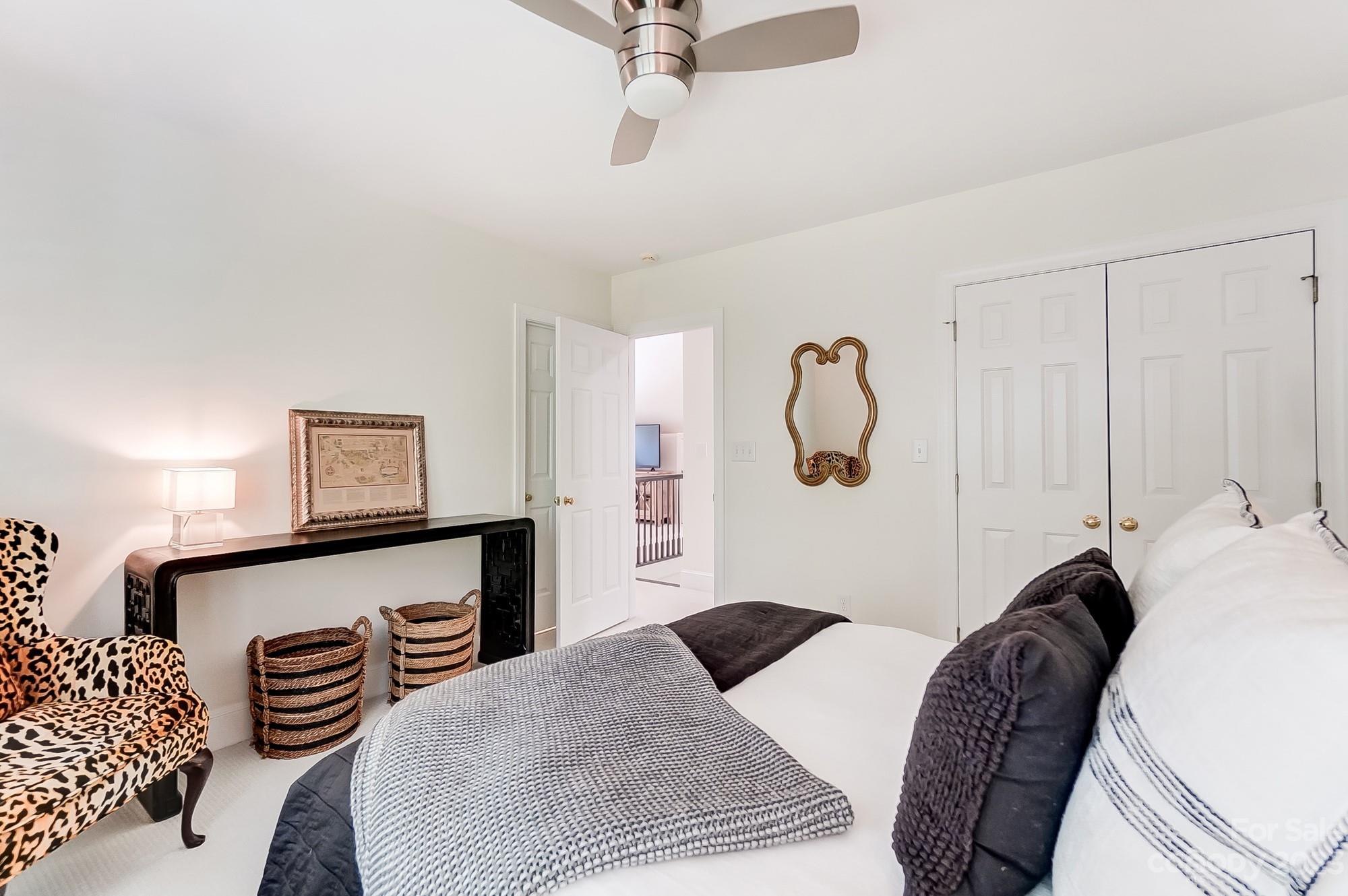 2407 Queensland Drive Charlotte, NC 28270 - Photo 33 of 42 a bedroom with a bed and a chandelier