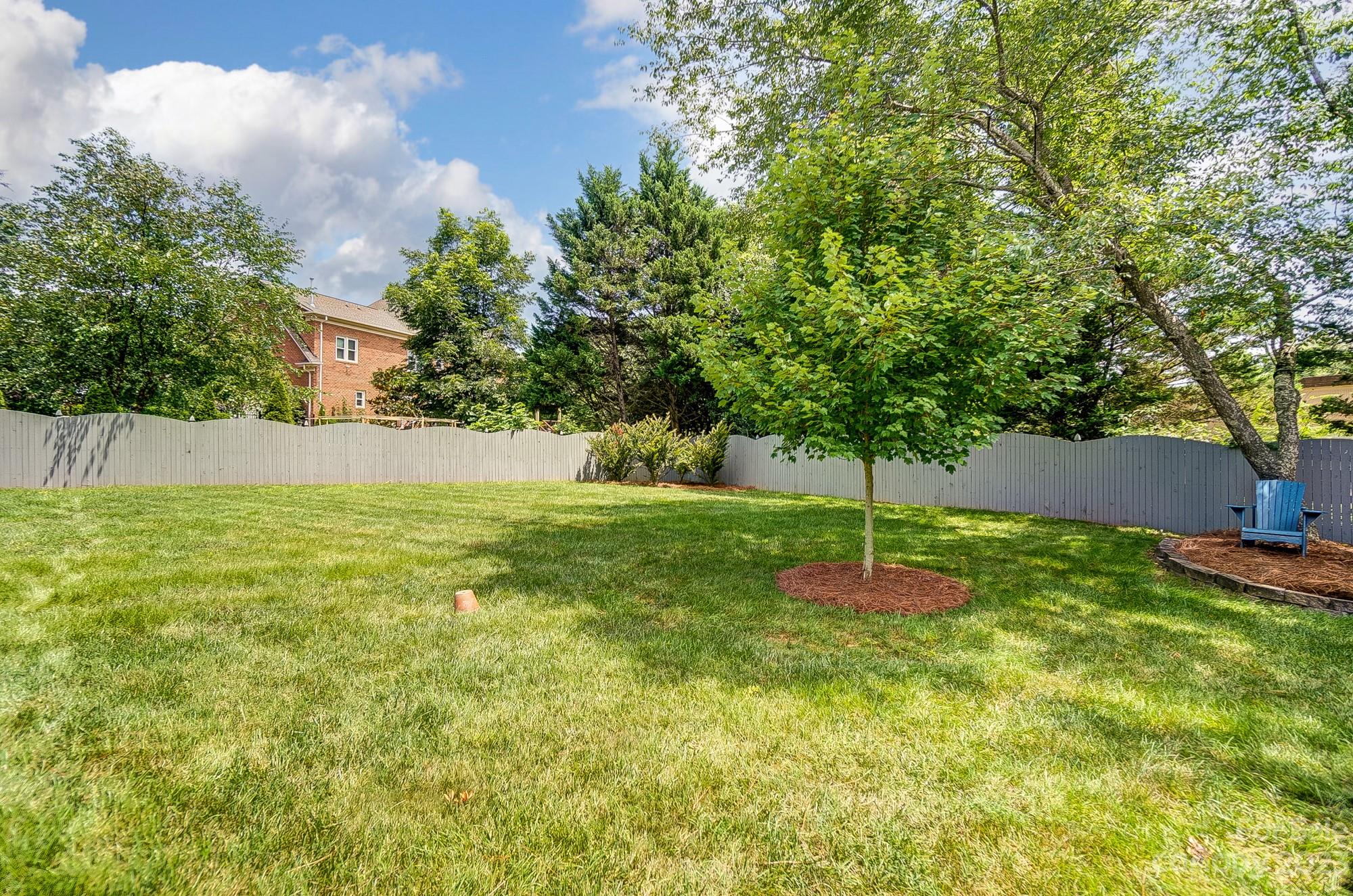 2407 Queensland Drive Charlotte, NC 28270 - Photo 39 of 42 a backyard of a house with lots of green space