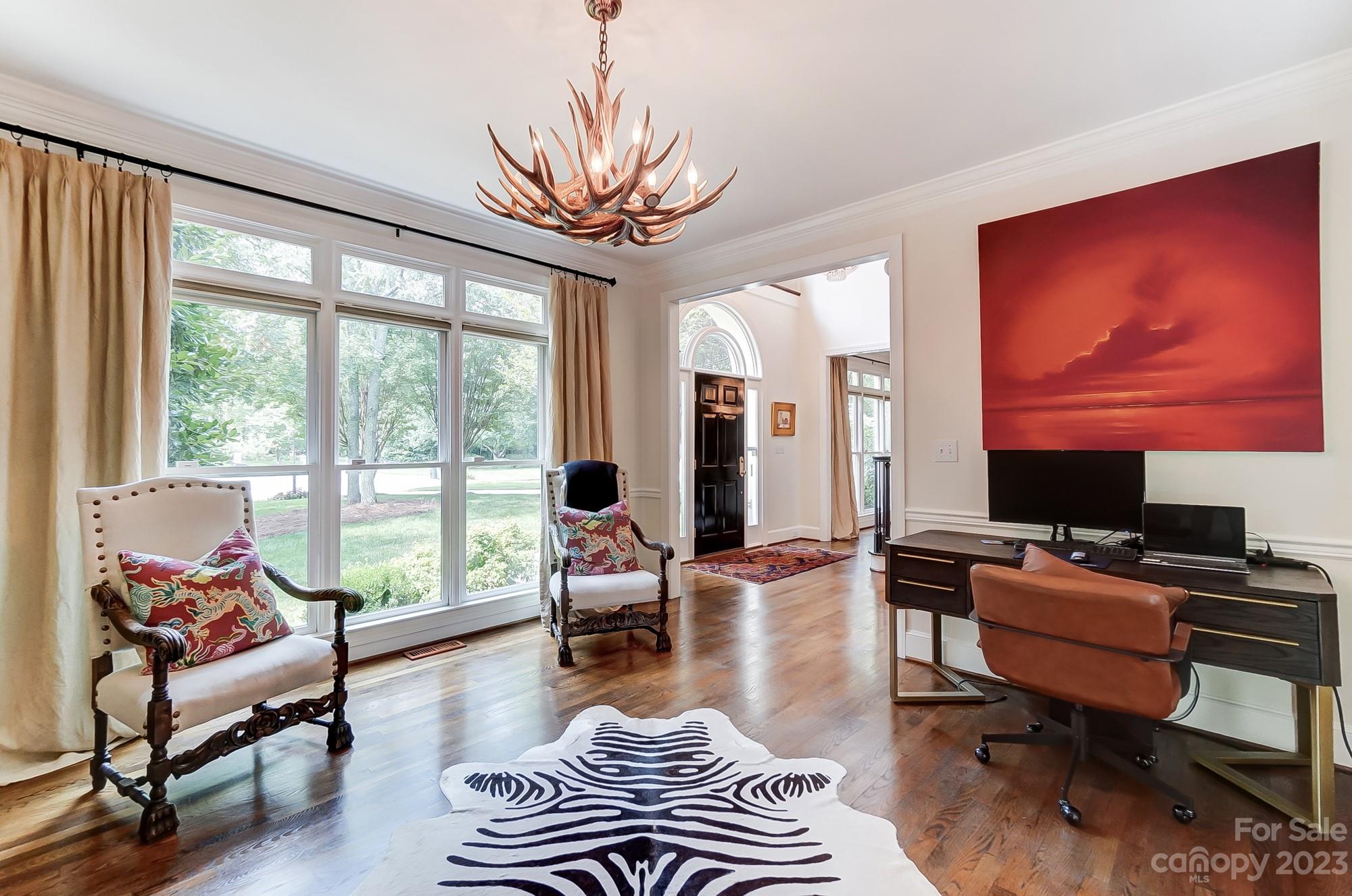 2407 Queensland Drive Charlotte, NC 28270 - Photo 5 of 42 a living room with furniture a rug potted plant and a large window
