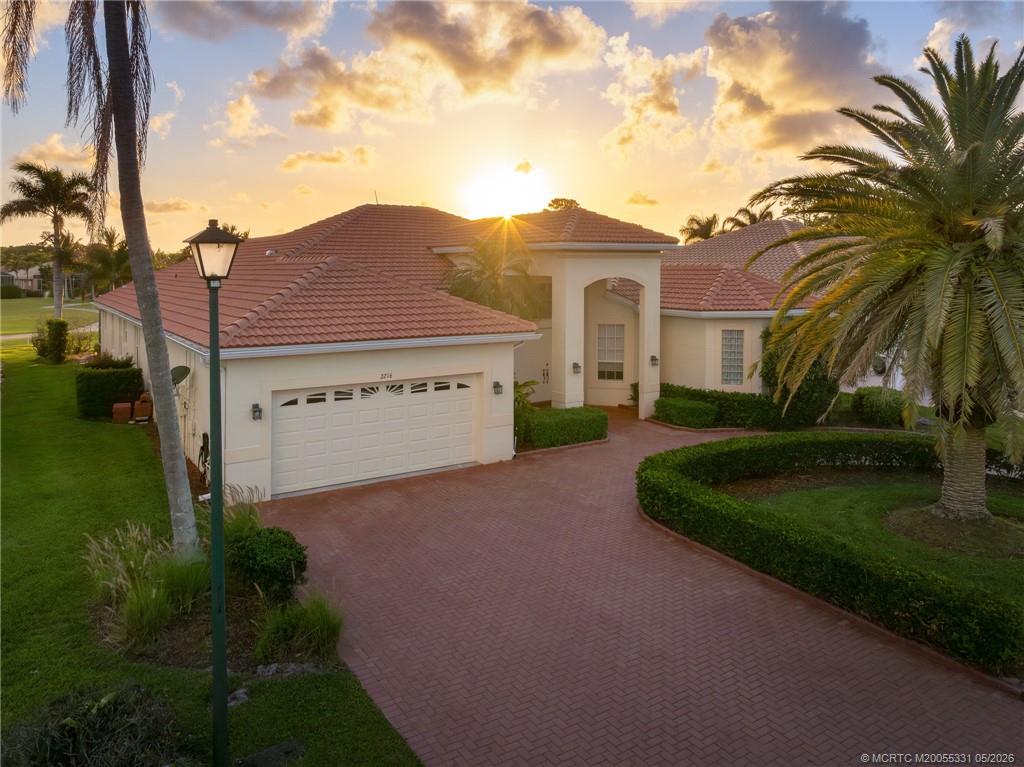 2216 Southeast Stonehaven Road Port St. Lucie, FL 34952 - Photo 45 of 67 a view of a house with a yard and potted plants