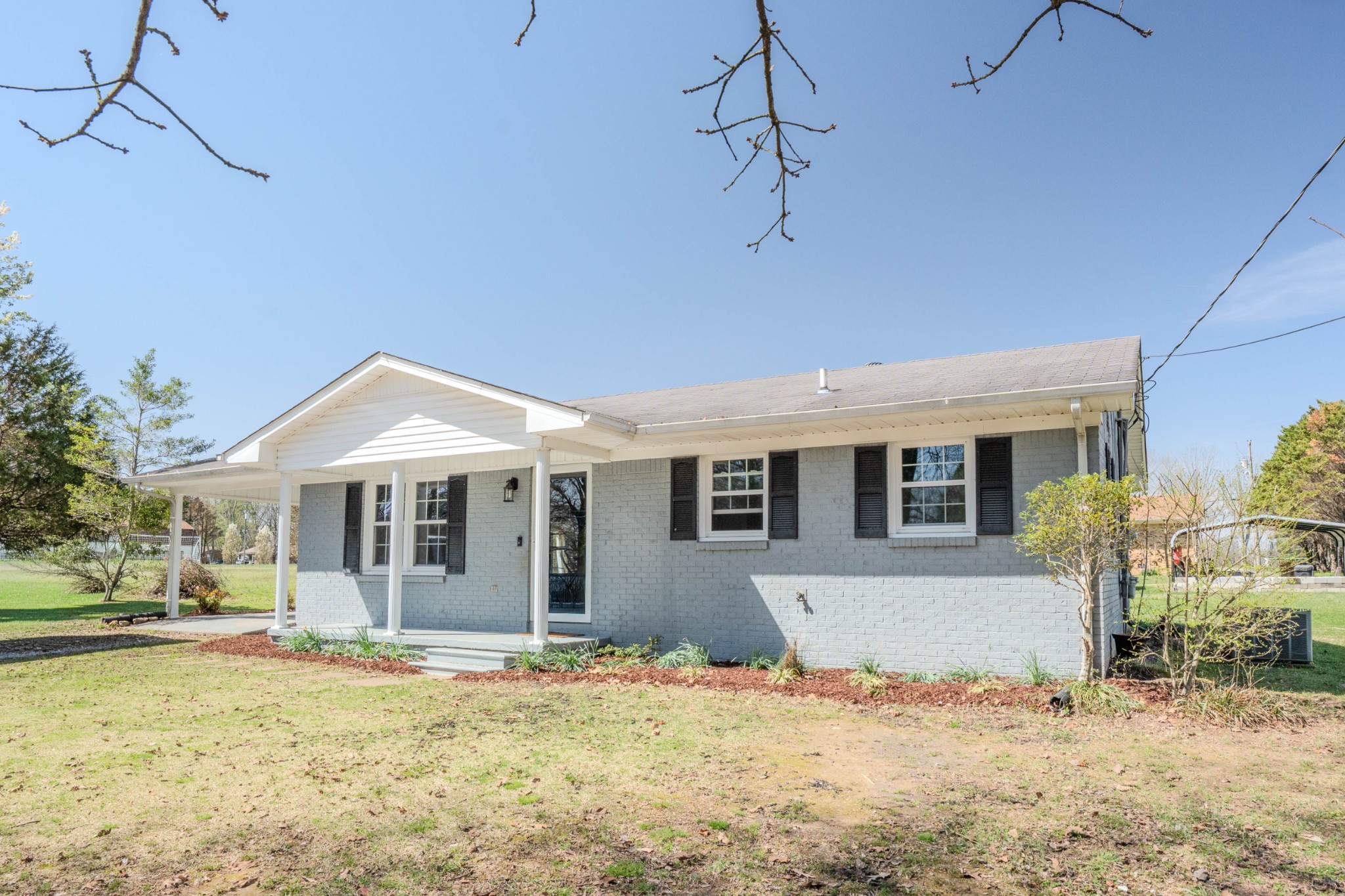 705 North Military Street Loretto, TN 38469 - Photo 1 of 16 a front view of a house with a yard