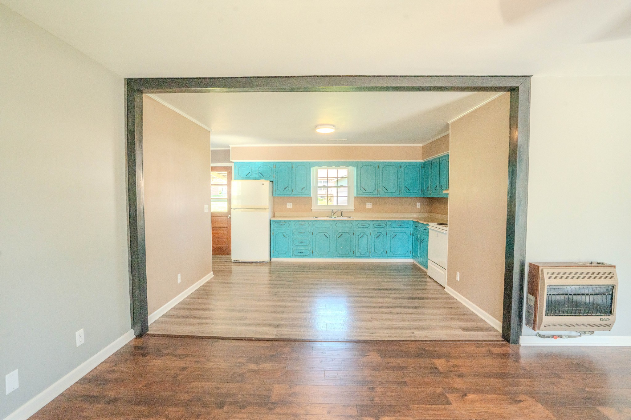 705 North Military Street Loretto, TN 38469 - Photo 11 of 16 a view of an empty room with wooden floor and a window