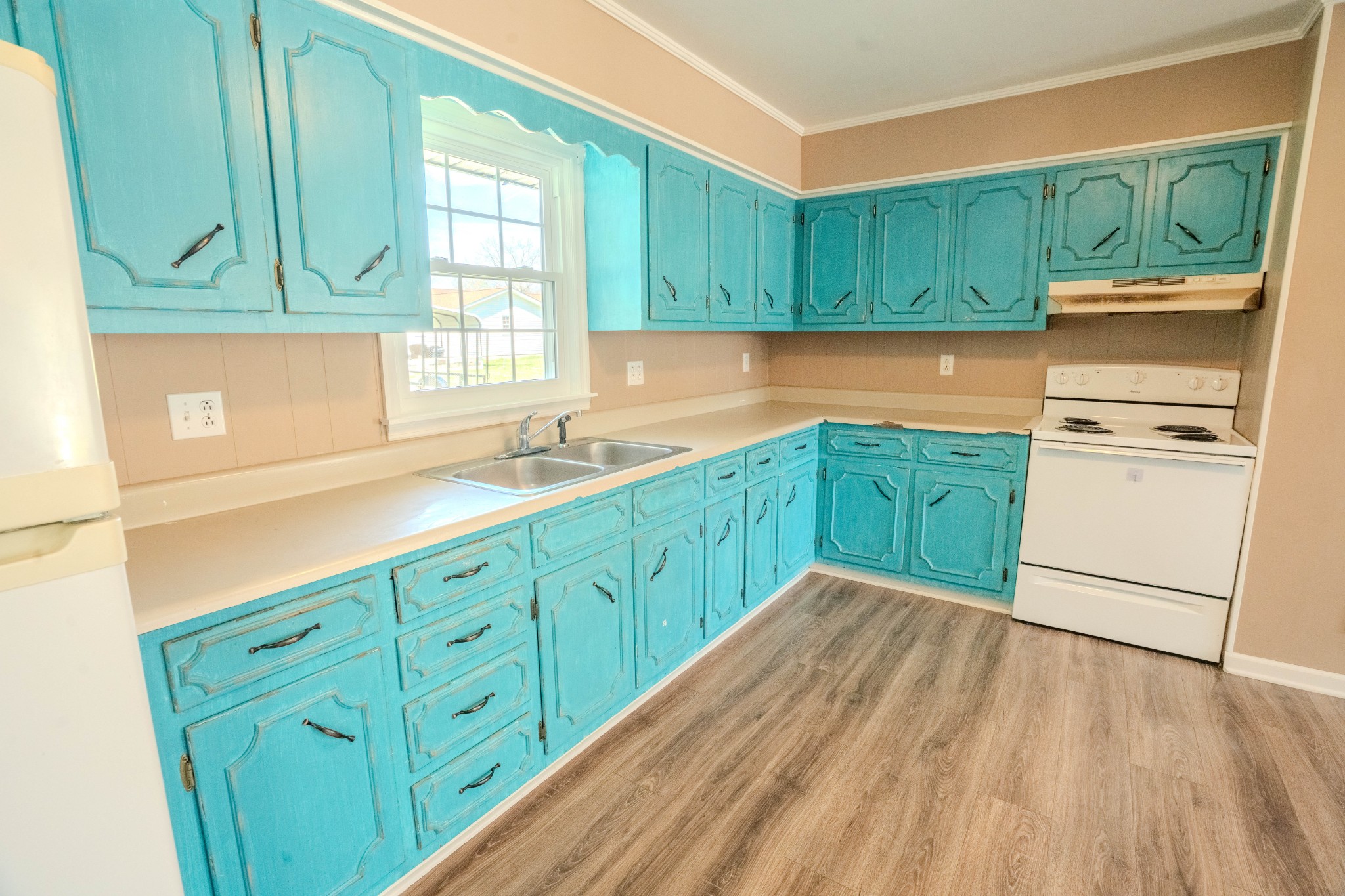 705 North Military Street Loretto, TN 38469 - Photo 12 of 16 a kitchen with stainless steel appliances granite countertop wooden cabinets a sink and a dishwasher