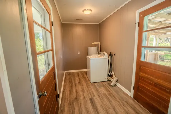 a view of a room with wooden floor and a window