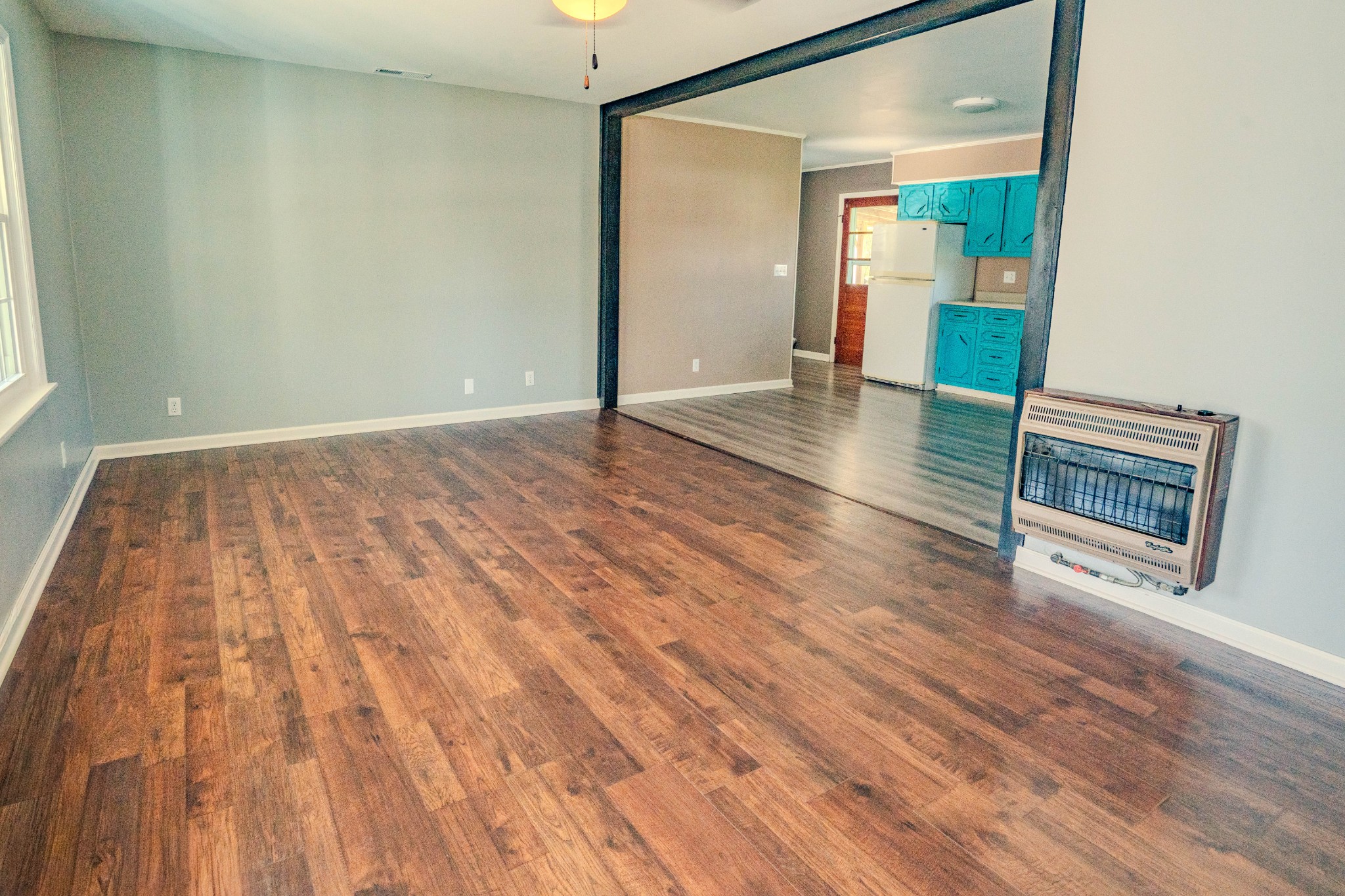 705 North Military Street Loretto, TN 38469 - Photo 7 of 16 an empty room with wooden floor and mirror