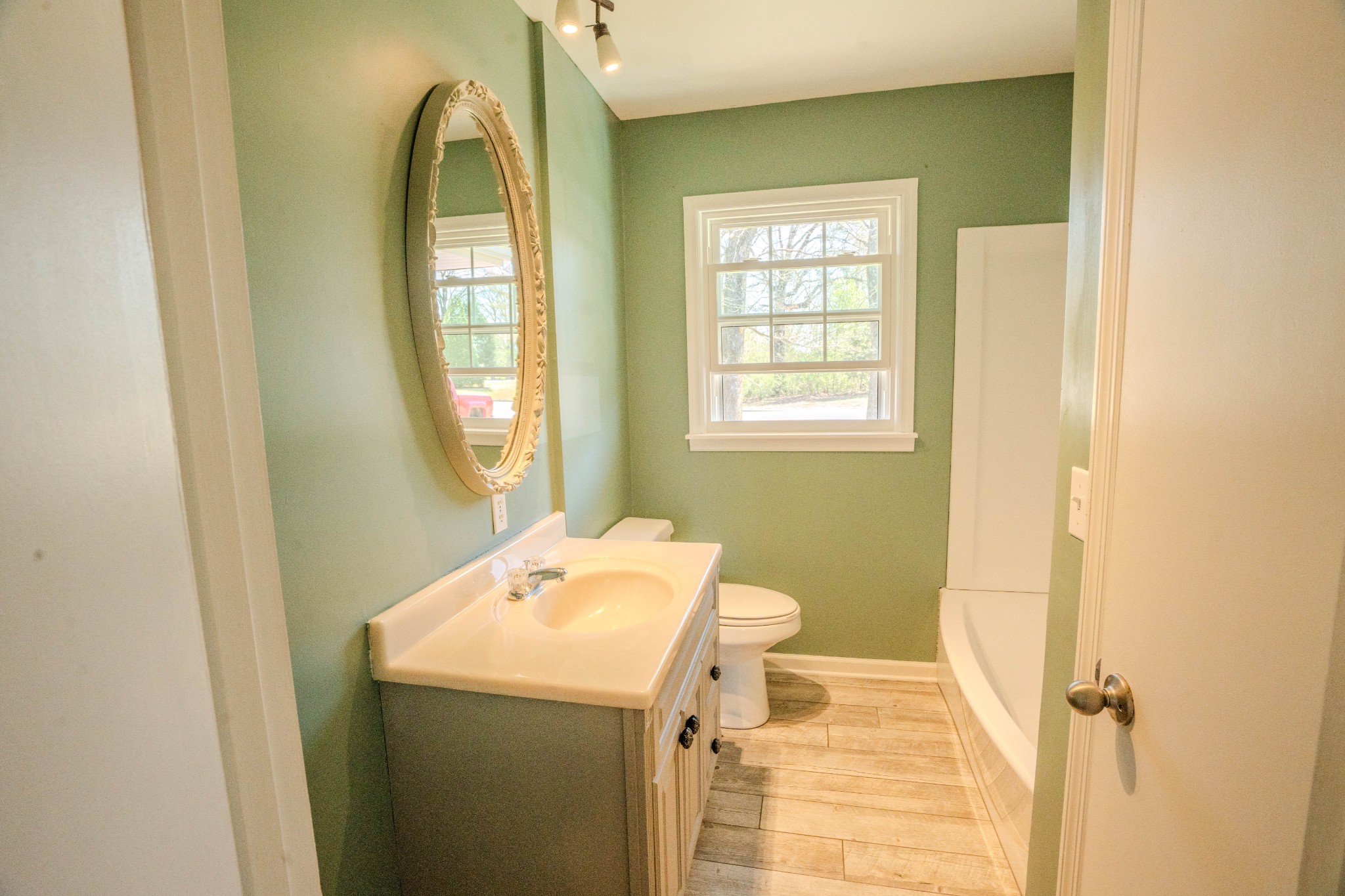 705 North Military Street Loretto, TN 38469 - Photo 9 of 16 a bathroom with a sink and a mirror