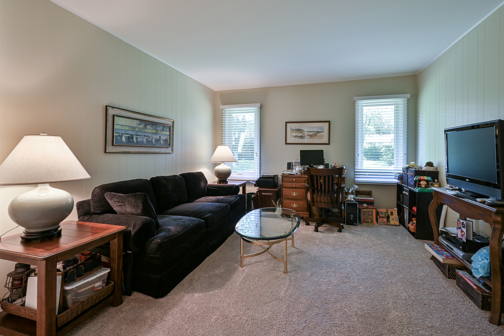 2S050 Taylor Road Glen Ellyn, IL 60137 - Photo 18 of 24 a living room with furniture a flat screen tv and a window