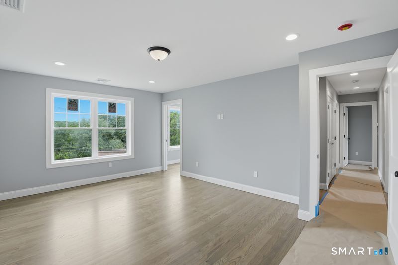 796 Maple Hill Road Naugatuck, CT 06770 - Photo 21 of 35 an empty room with wooden floor and windows