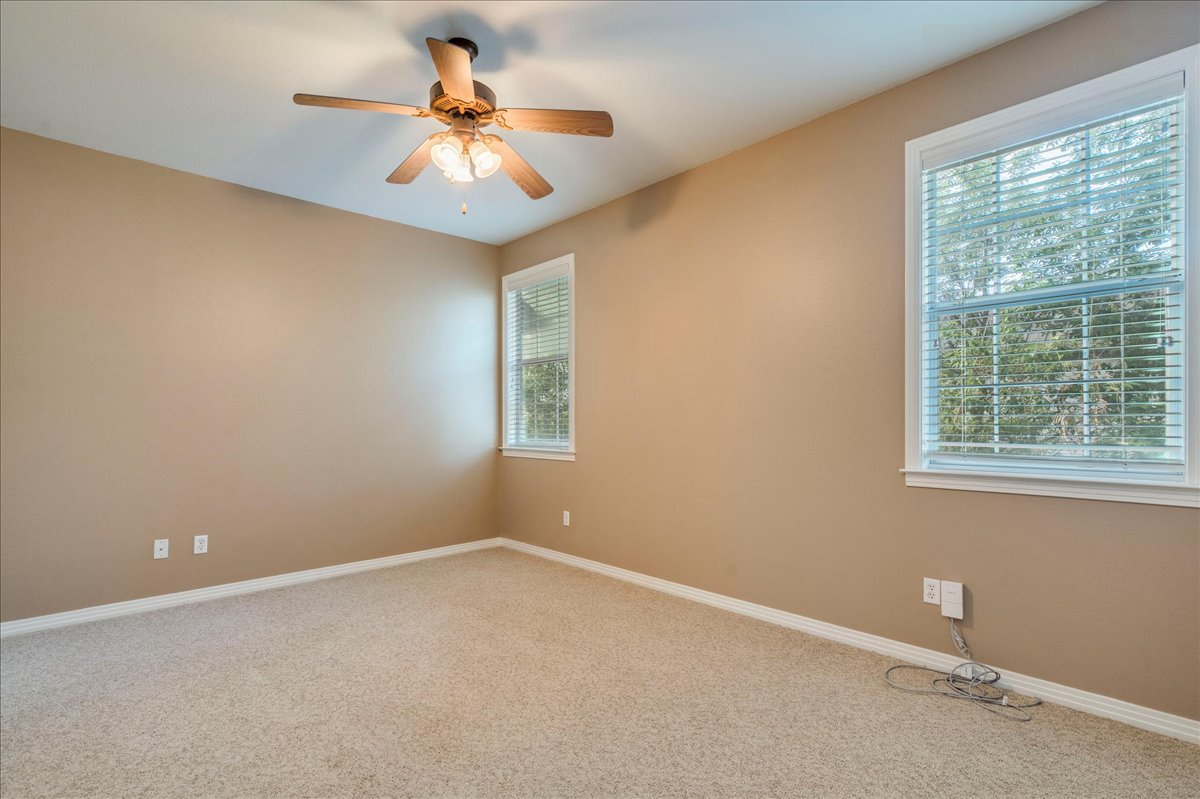 2115 Bluebonnet Lane, Unit 4A Austin, TX 78704 - Photo 17 of 29 an empty room with a window and a fan