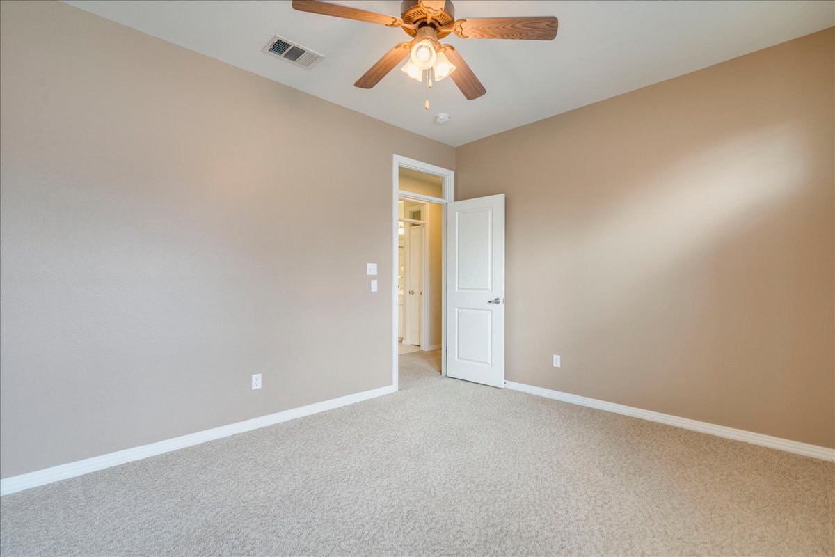 2115 Bluebonnet Lane, Unit 4A Austin, TX 78704 - Photo 20 of 29 an empty room with chandelier fan and windows