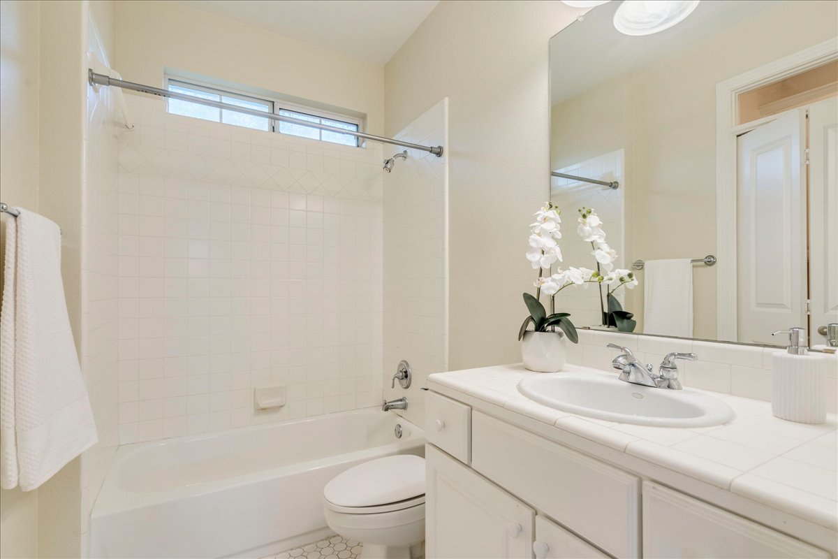 2115 Bluebonnet Lane, Unit 4A Austin, TX 78704 - Photo 21 of 29 a bathroom with a granite countertop sink toilet and shower