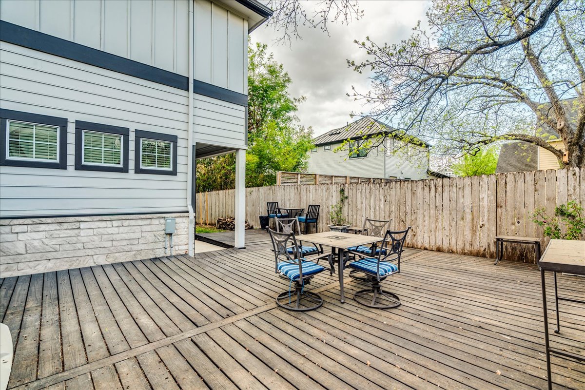 2115 Bluebonnet Lane, Unit 4A Austin, TX 78704 - Photo 25 of 29 a view of a patio with table and chairs and wooden floor