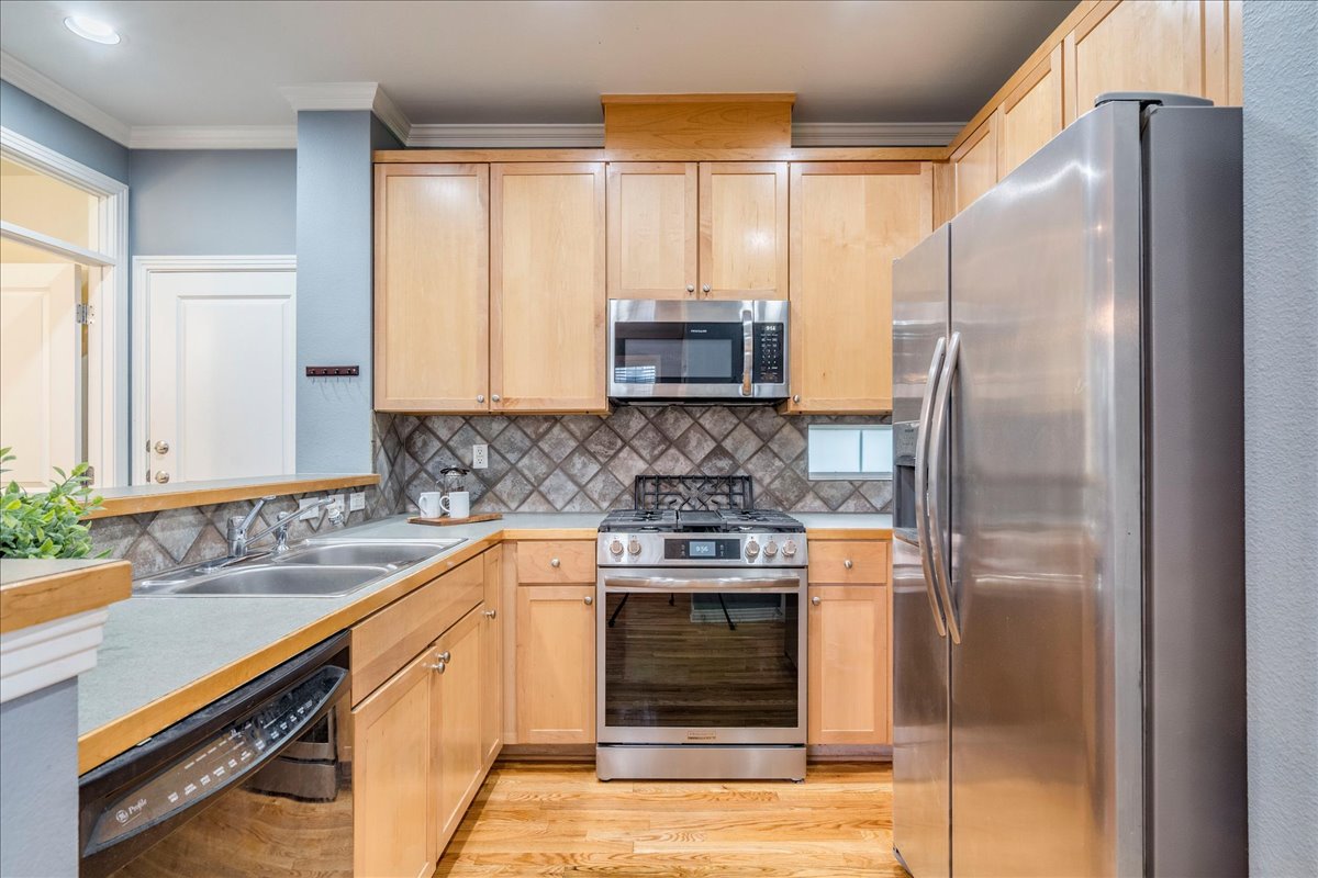 2115 Bluebonnet Lane, Unit 4A Austin, TX 78704 - Photo 7 of 29 a kitchen with a refrigerator and a sink