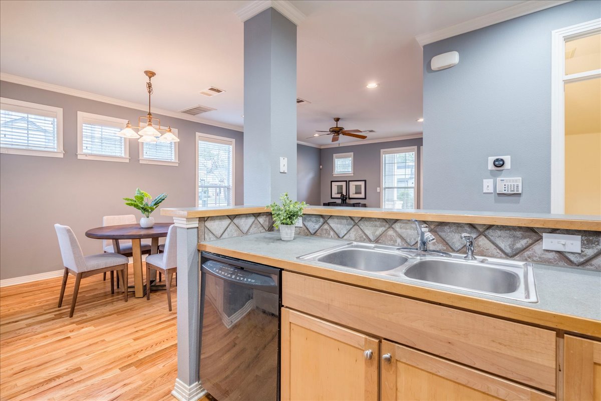 2115 Bluebonnet Lane, Unit 4A Austin, TX 78704 - Photo 9 of 29 a kitchen with a sink cabinets and wooden floor