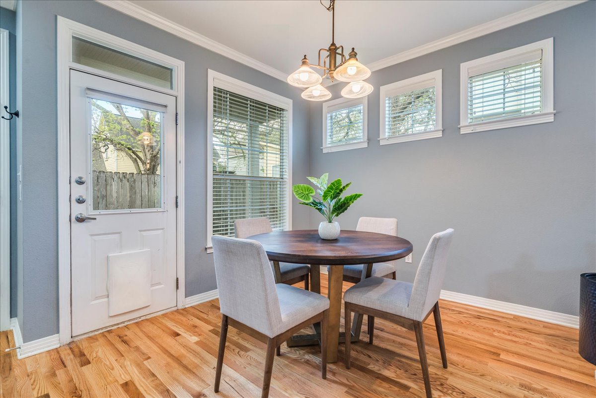 2115 Bluebonnet Lane, Unit 4A Austin, TX 78704 - Photo 10 of 29 a view of a dining room with furniture wooden floor and chandelier