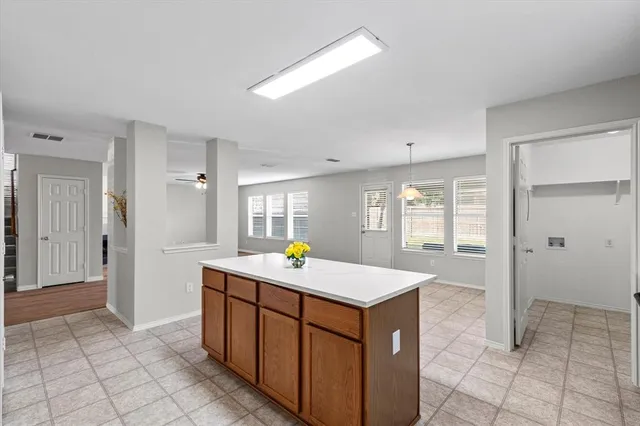 a kitchen that has a sink a stove and a refrigerator