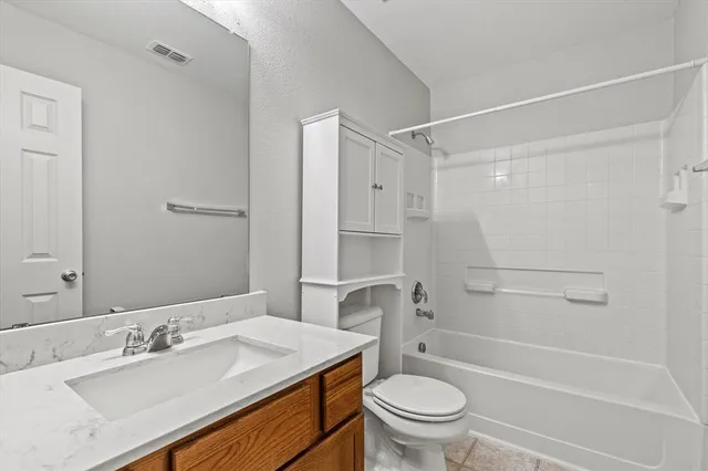 a bathroom with a sink toilet vanity and shower