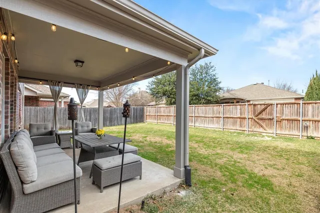 a patio with yard glass top table and chairs