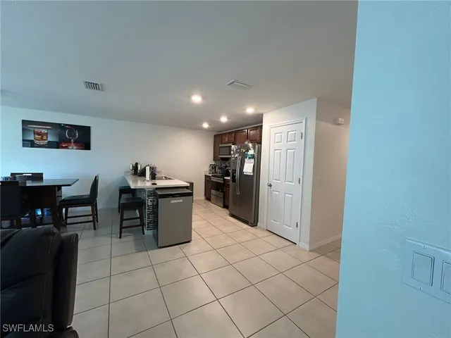 a view of a chair and table in backyard of the house