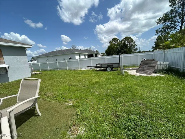 a view of a backyard with plants and a patio