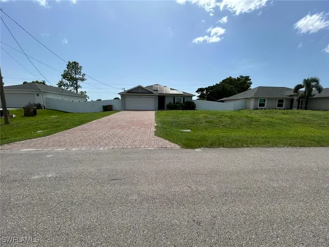 a view of a house with a yard and garage