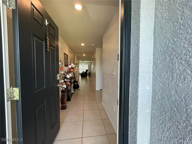 a view of a hallway with wooden shelves