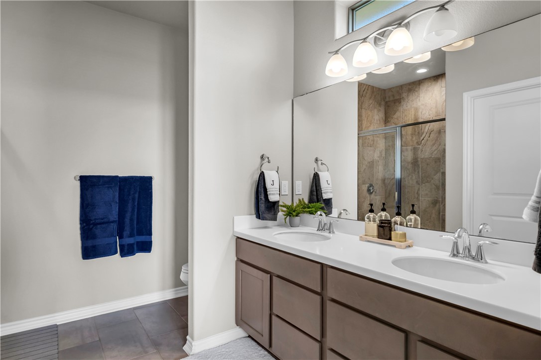 1033 Ocean Breeze Portland, TX 78374 - Photo 17 of 38 a bathroom with a double vanity sink and a mirror