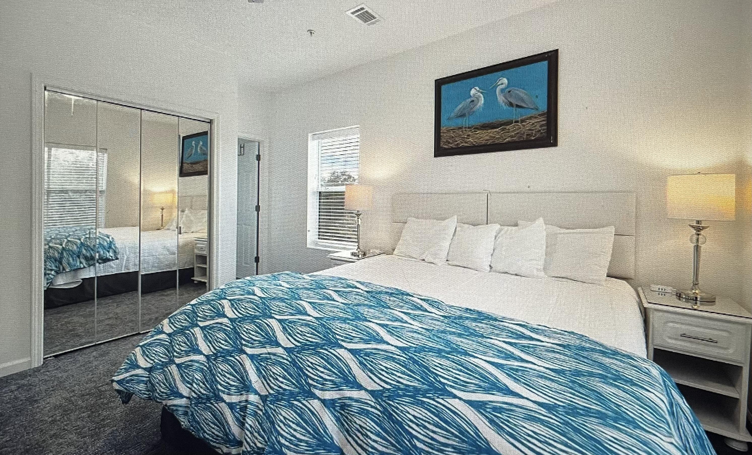 34 Heron's Watch Way, Unit 2304 Santa Rosa Beach, FL 32459 - Photo 11 of 56 a bedroom with a bed and a mirror