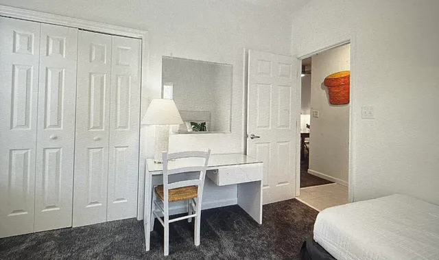 a bedroom with a bed and a table in it