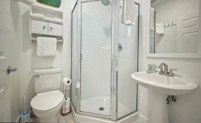 a bathroom with a sink toilet and shower