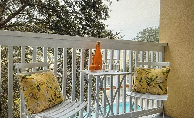a view of a balcony with wooden fence and floor