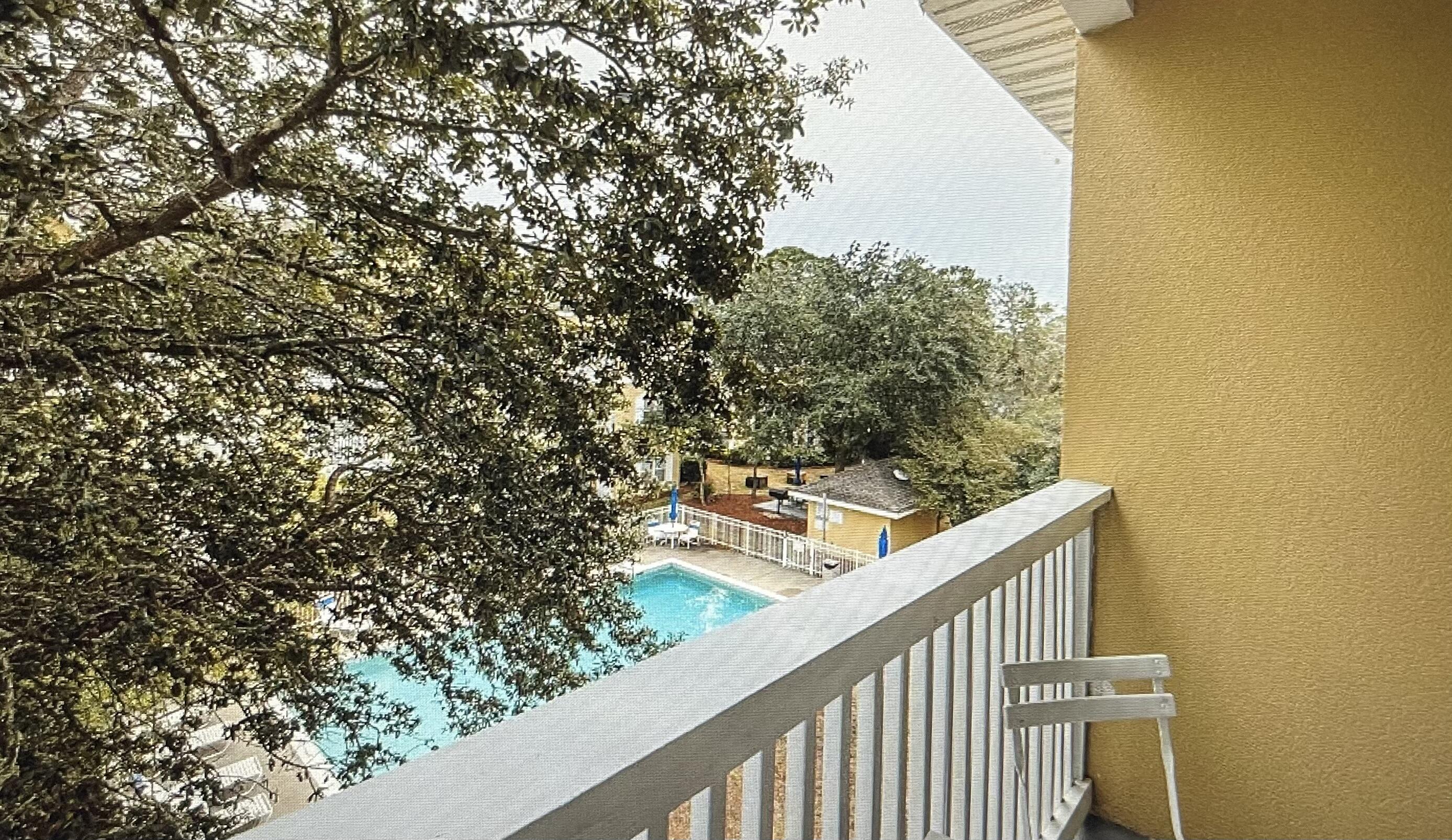 34 Heron's Watch Way, Unit 2304 Santa Rosa Beach, FL 32459 - Photo 21 of 56 a view of a balcony with wooden fence and floor