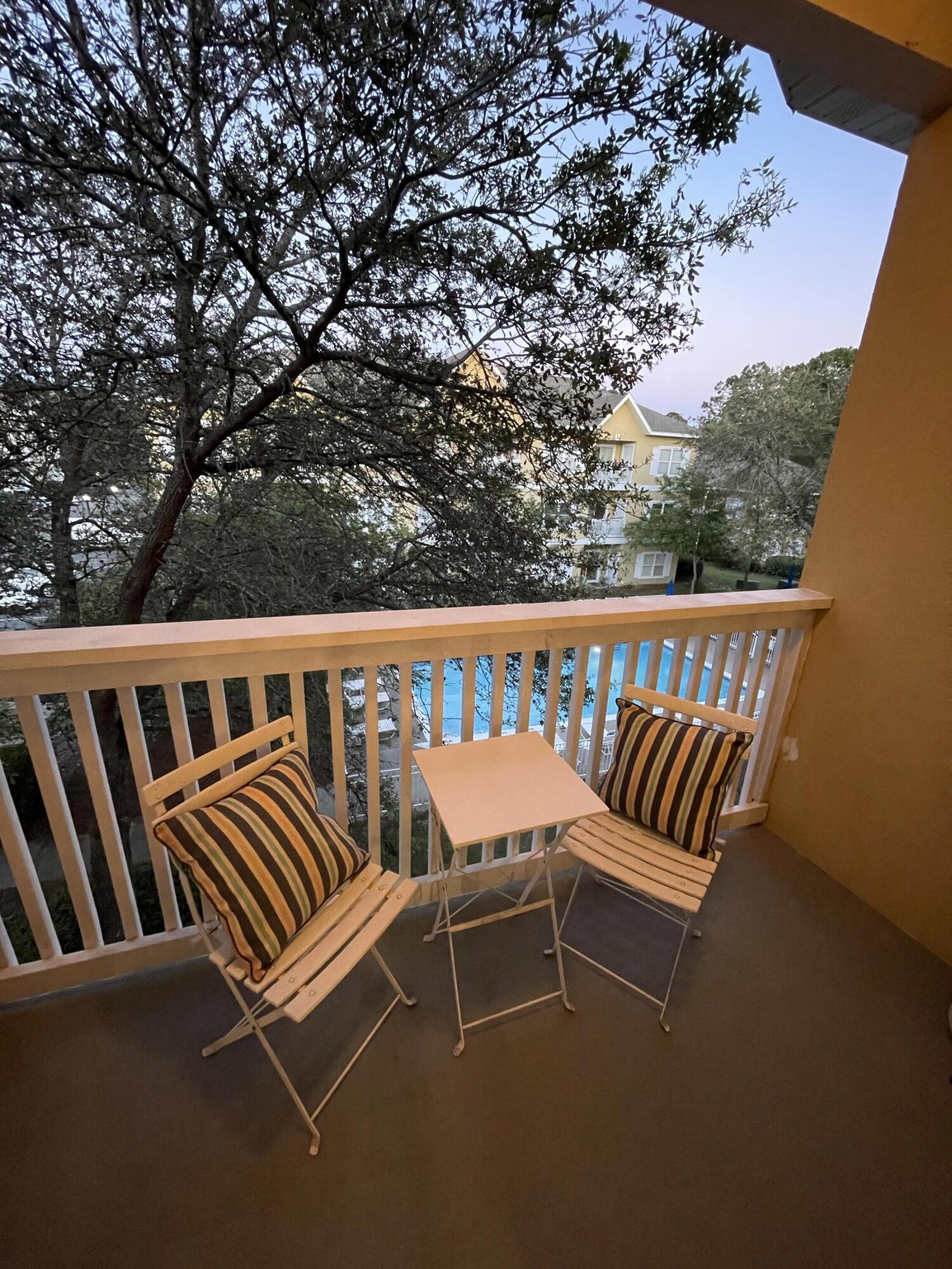 34 Heron's Watch Way, Unit 2304 Santa Rosa Beach, FL 32459 - Photo 26 of 56 a balcony with a bench sitting in the middle